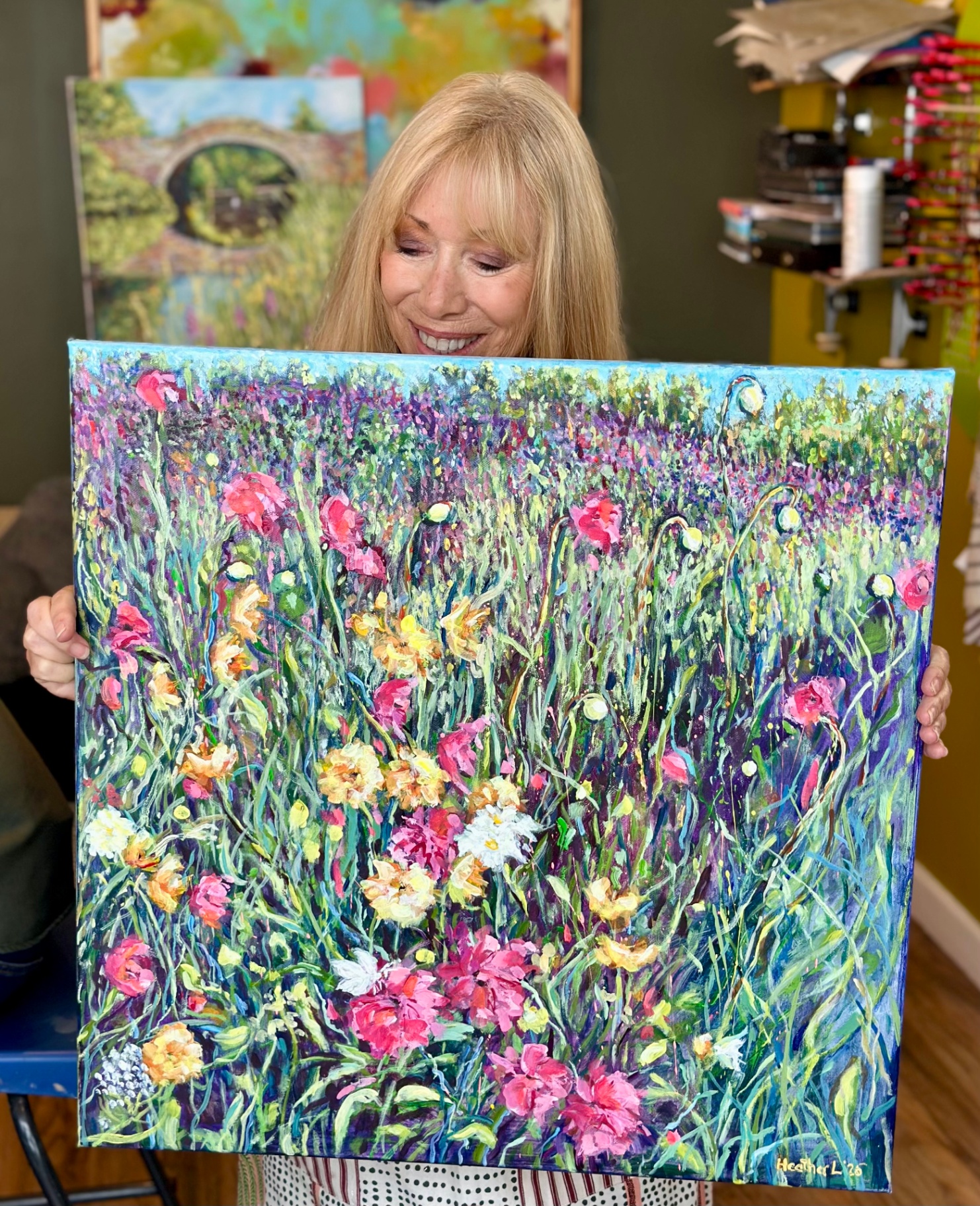 Artist with sold wildflower meadow painting - Sold - Studio photograph by Heather Lavender
